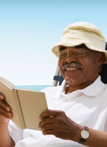 picture of a man reading on the beach