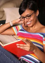woman reading a book while smiling